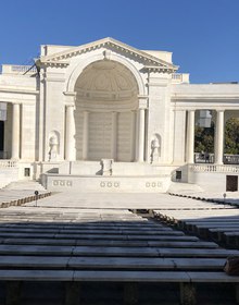 Empty marble benches facing the Memorial Amphitheater