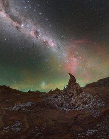 The Milky Way arching over a rock spire