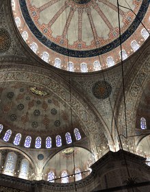 Blue tiled semi-domes and stained glass