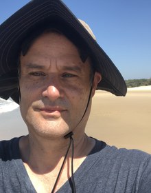 Me on the beach in a wide-brimmed hat