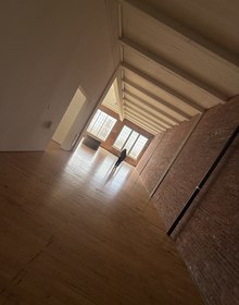 Window light striping the wide plank floor
