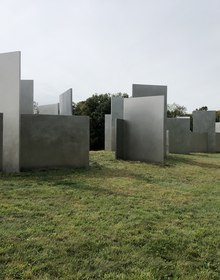 A field of grey slabs standing in the meadow