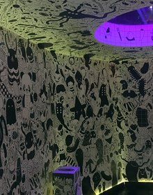 A room papered floor to ceiling in black-and-white creatures