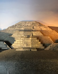 A full-size Teotihuacan reconstruction under warm light