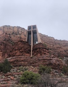 The chapel's concrete cross wedged into red sandstone