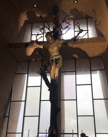 The crucifix against the great window over the red rocks