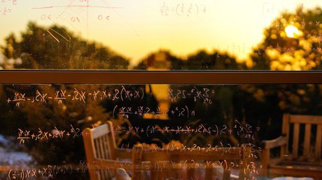 Equations written on the window against the piñon and the sunset