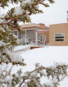 The adobe buildings of the Cowan Campus in snow