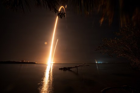 A Falcon 9 going up over the water at night
