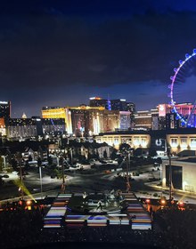 The screen showing the Strip and the High Roller behind the stage
