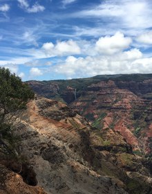 The red walls of Waimea Canyon under cloud