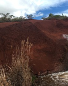 A waterfall over red earth